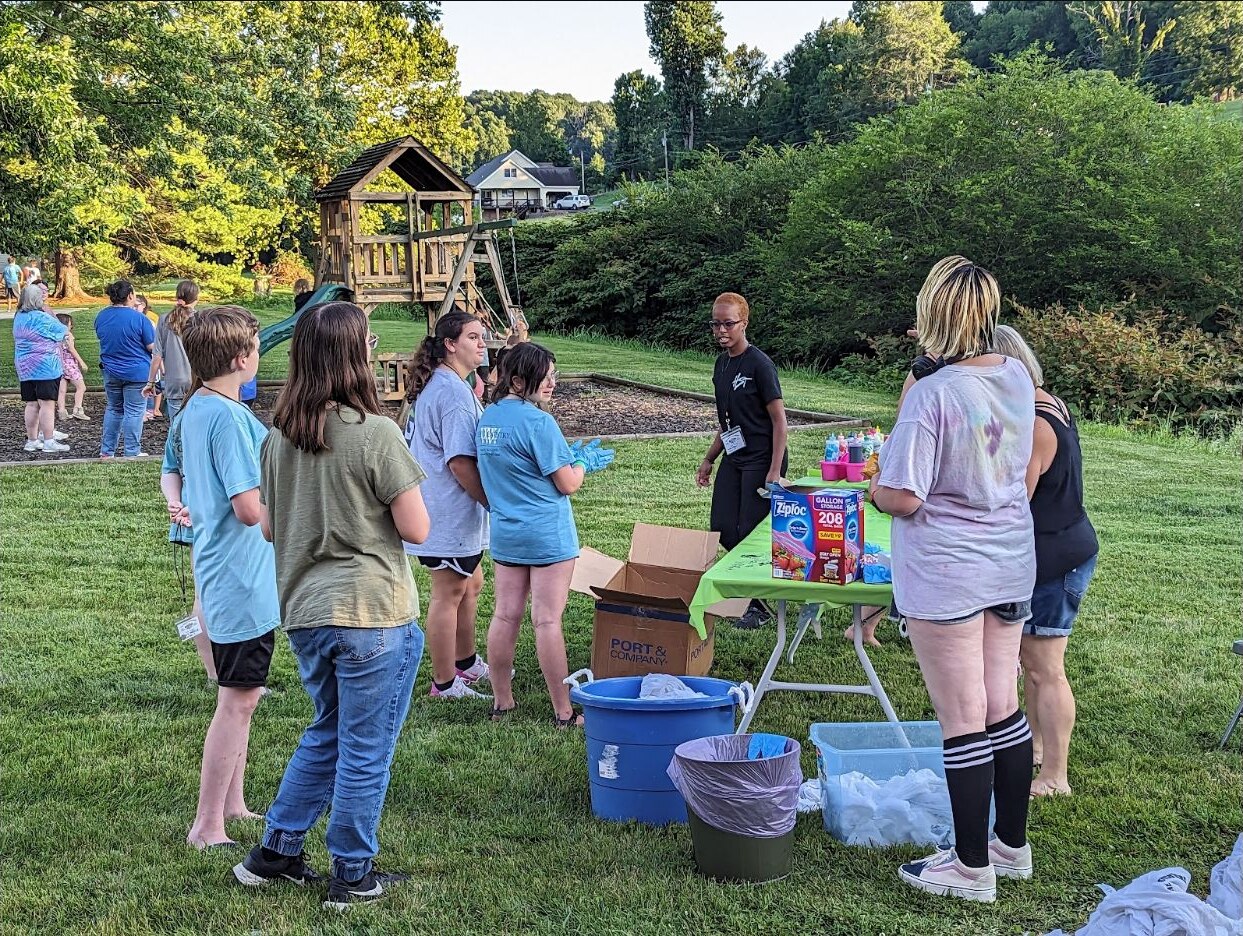 Young people and adults enjoying an outdoor church event